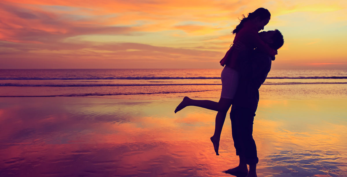 Couple on beach during sunset
